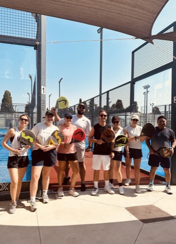 Group holding padel rackets together